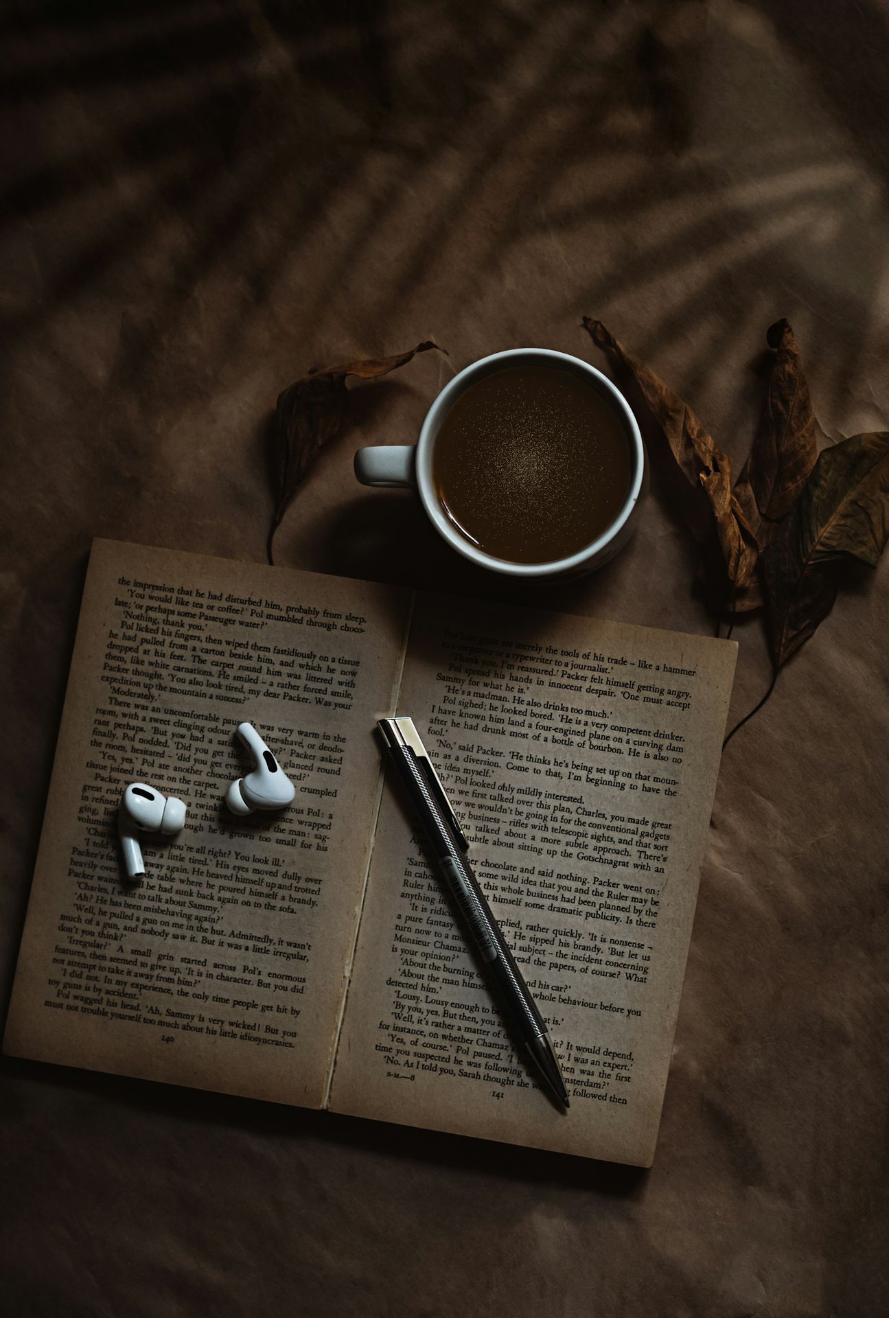white ceramic mug on book page